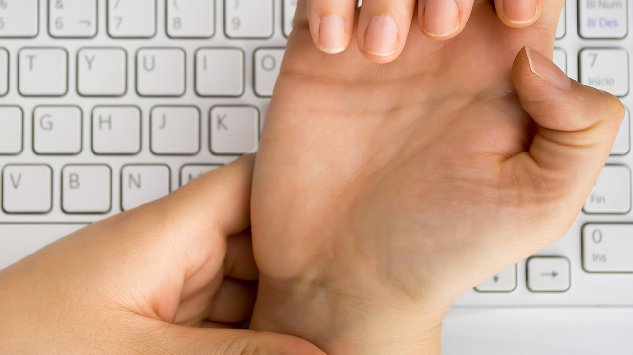 .worker with pain on the wrist by the hard work at the office.
