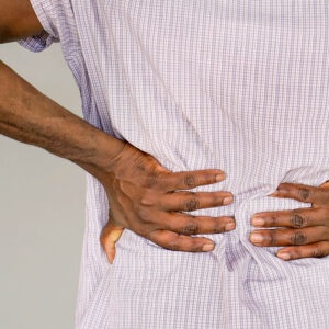 African man, pain at lower back African man, pain at lower back