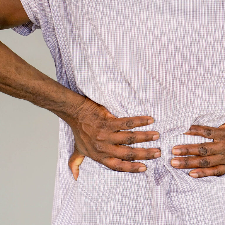 African man, pain at lower back